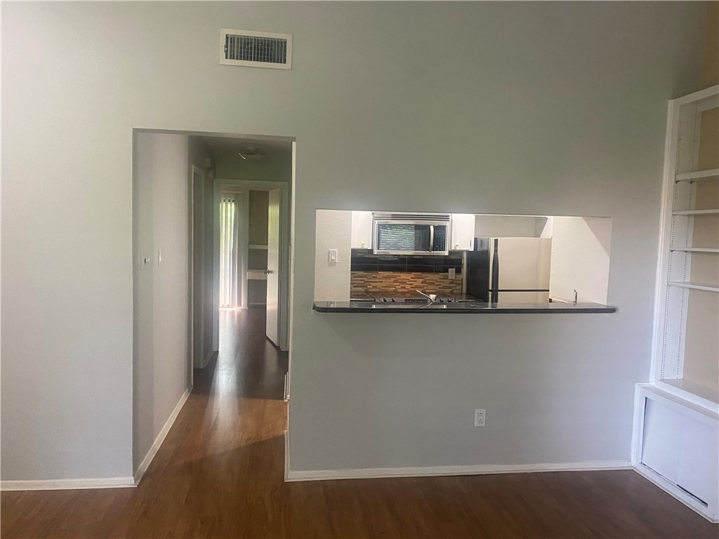 612 Park Place, Unit 303 Austin, TX 78705 - Photo 6 of 26 a kitchen with stainless steel appliances granite countertop a refrigerator a sink a stove and microwave