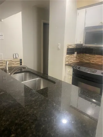 a bathroom with a toilet a sink and bathtub