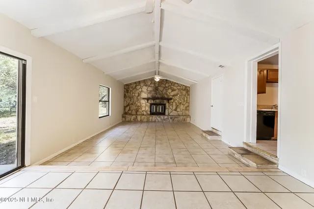 a view of entryway and bedroom with windows