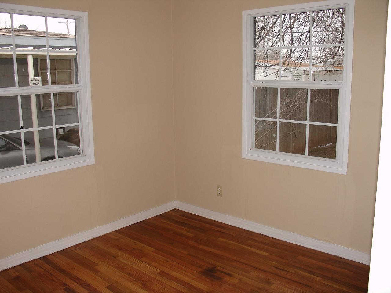 4626 Bowie Street Amarillo, TX 79110 - Photo 3 of 5 a view of empty room with wooden floor and fan