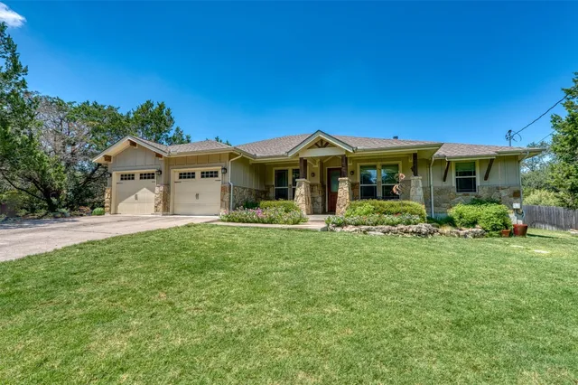 a front view of a house with yard porch and green space
