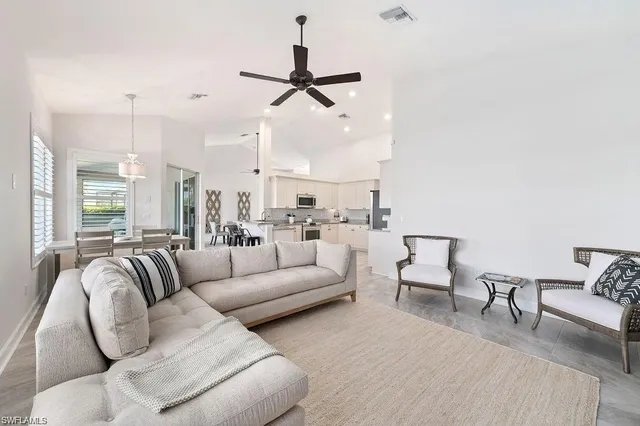 a kitchen with granite countertop a sink and white cabinets