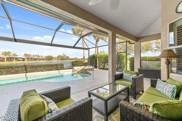 a living room with furniture and a floor to ceiling window