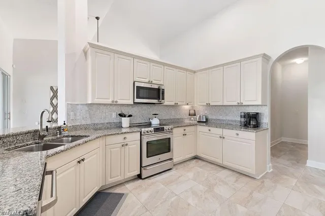 a dining room with furniture a rug and a large window