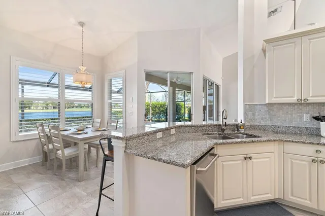 a dining room with furniture a chandelier and wooden floor