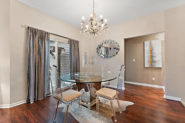 a kitchen with refrigerator and chairs