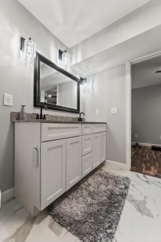 a bathroom with a granite countertop shower