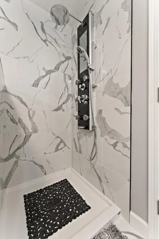 a bathroom with a granite countertop sink a toilet and shower