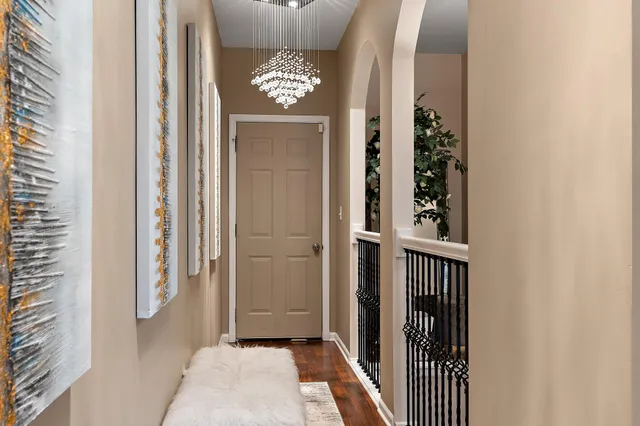 a bedroom with a large bed and a chandelier