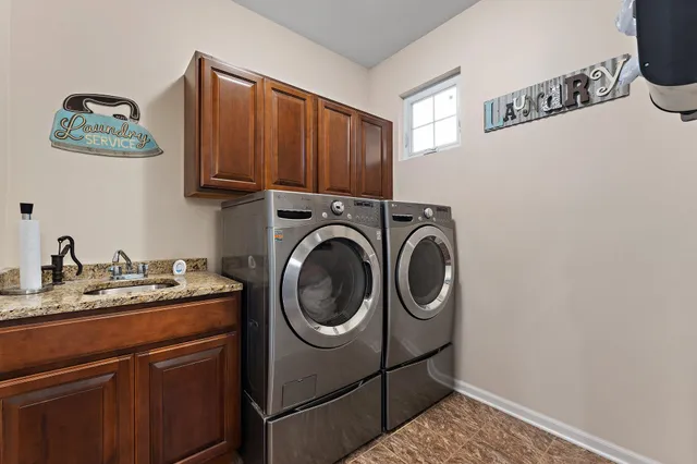 a bathroom with a granite countertop bathtub a sink and a window