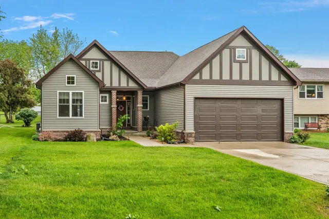 a front view of a house with a yard and garage
