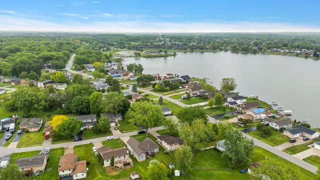 an aerial view of a house with a garden and trees all around