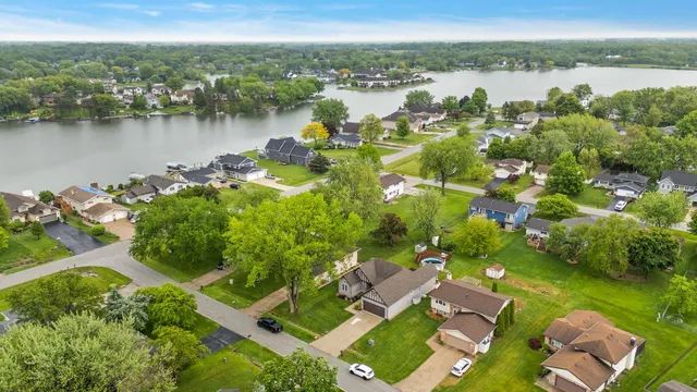 an aerial view of a house with a garden and trees