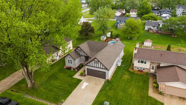 an aerial view of a house with a garden and lake view