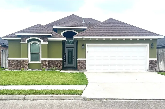 a front view of a house with a yard