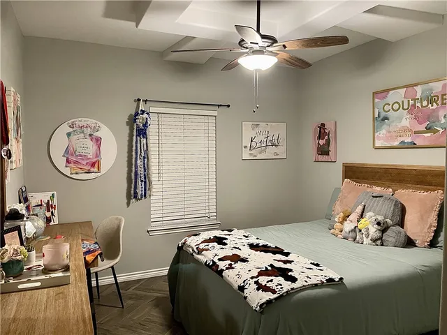 a bedroom with furniture and a chandelier fan
