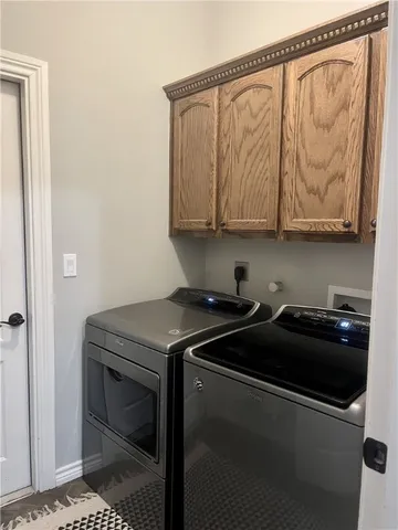 a view of a house with a yard and large trees
