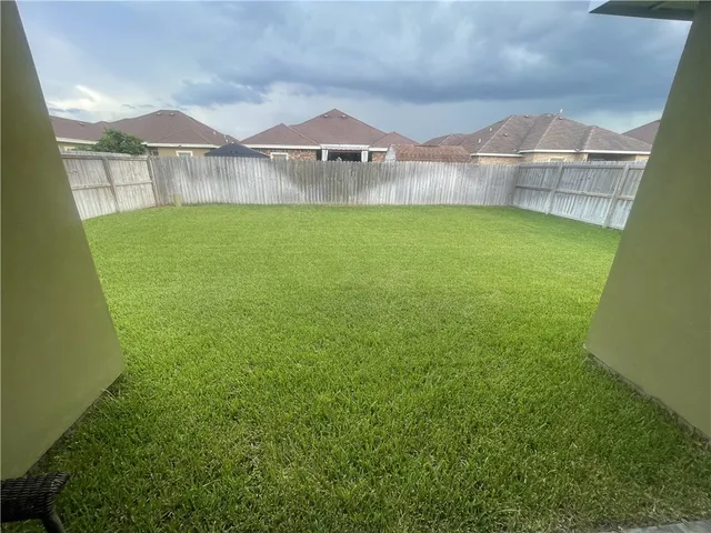 a view of a backyard with a wooden fence