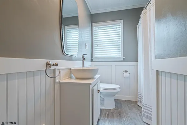 a bathroom with a sink toilet and window