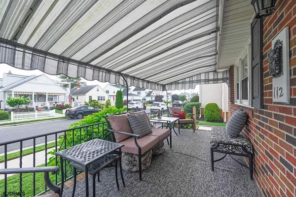 a view of a patio with couches table and chairs and potted plants