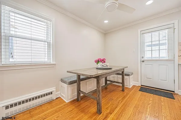 a view of a room with furniture and wooden floor