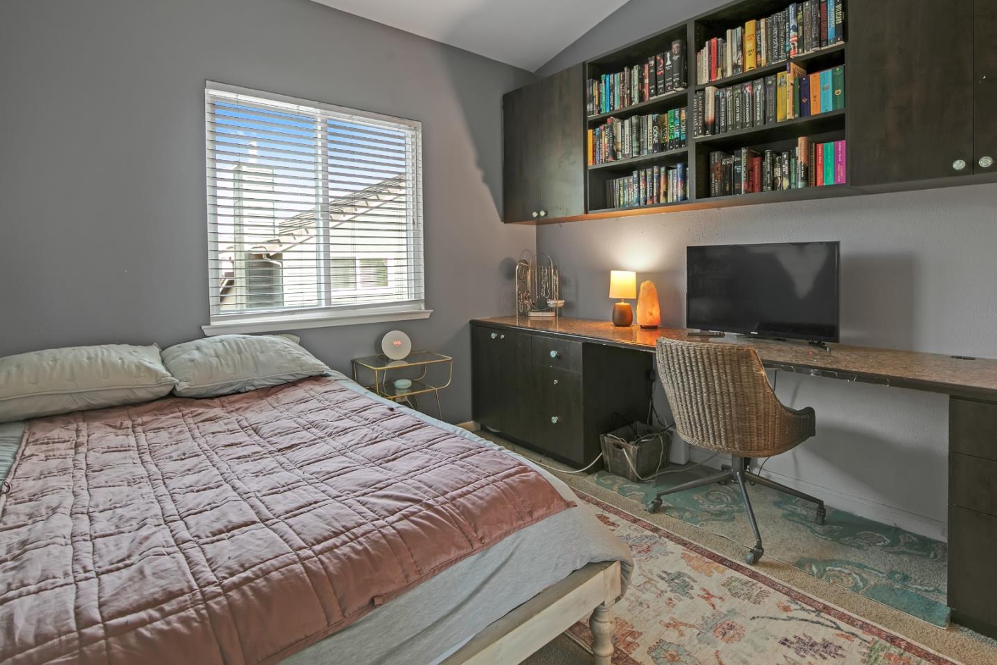 708 Coast Range Drive Scotts Valley, CA 95066 - Photo 25 of 37 a bedroom with a large bed and a bookshelf