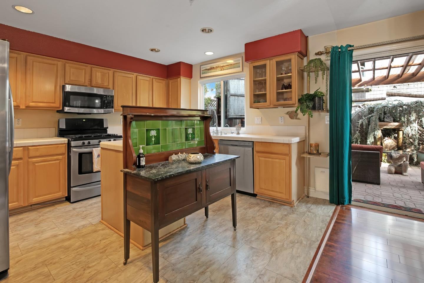 708 Coast Range Drive Scotts Valley, CA 95066 - Photo 9 of 37 a kitchen with kitchen island granite countertop a stove top oven a sink dishwasher and a fireplace with wooden floor