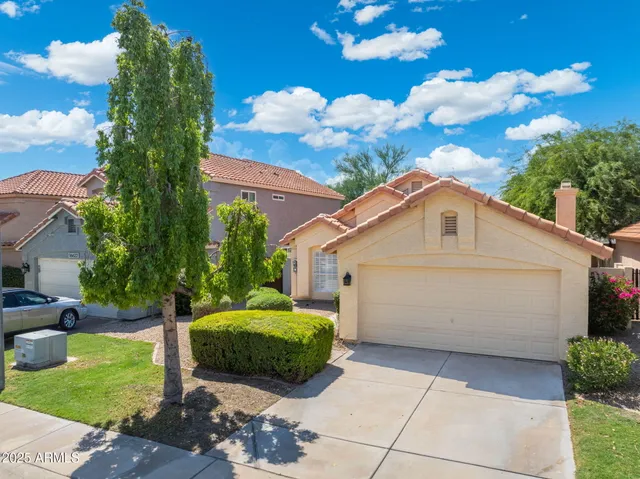 a view of a house with a backyard