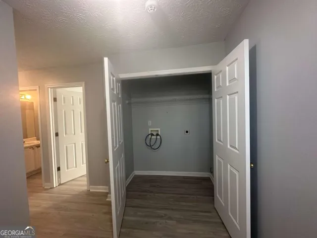 a view of a hallway with wooden floor