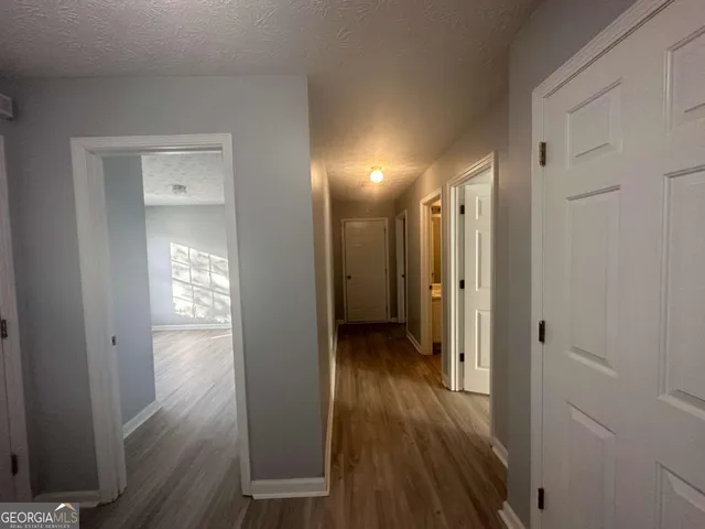 a view of hallway with wooden floor