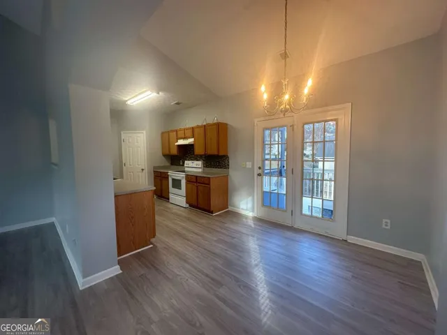a view of a kitchen with a sink oven a refrigerator and window
