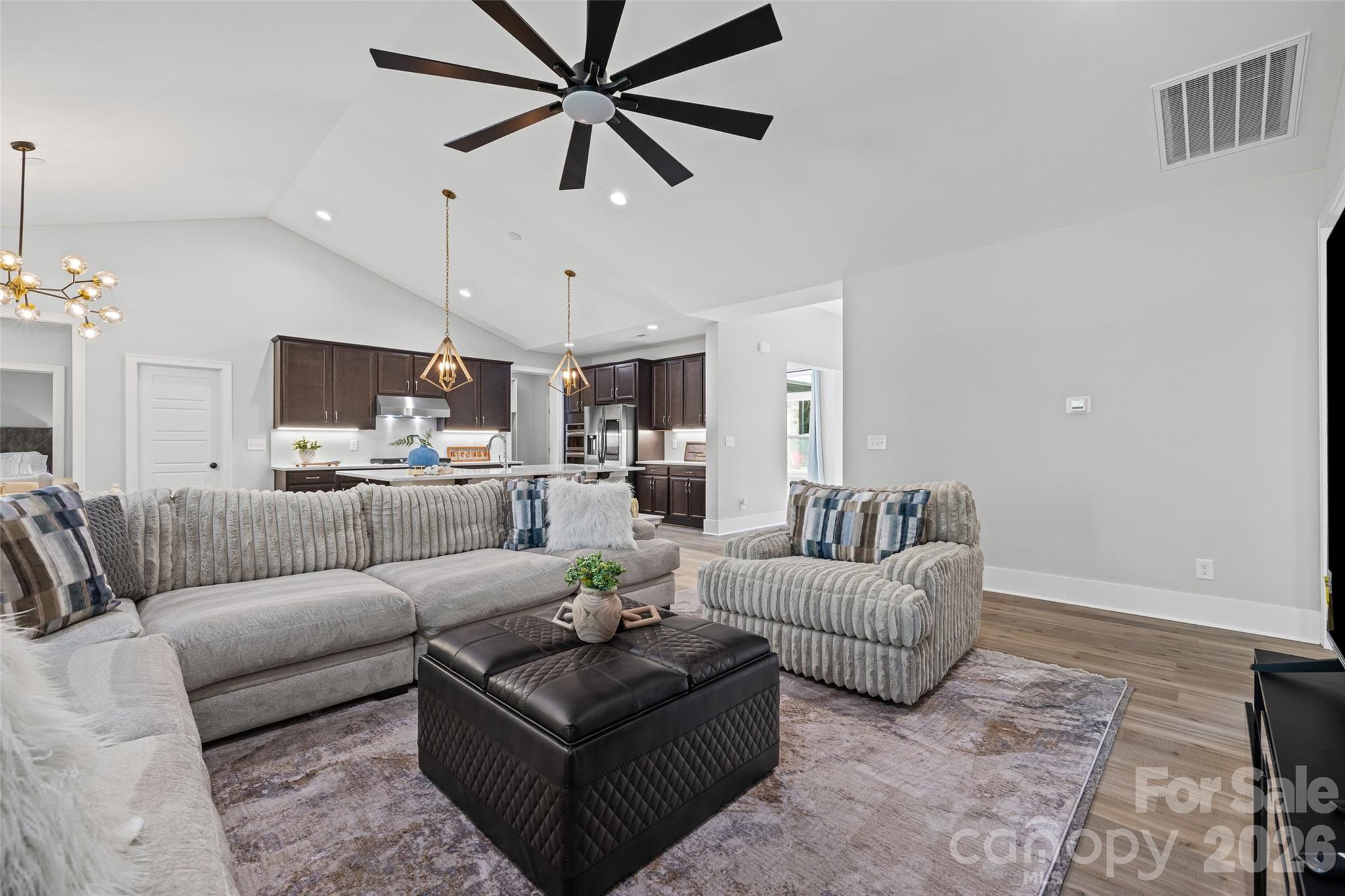 319 Inland Cove Court Clover, SC 29710 - Photo 15 of 47 a living room with furniture kitchen view and a chandelier