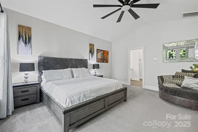 a bedroom with a bed and ceiling fan