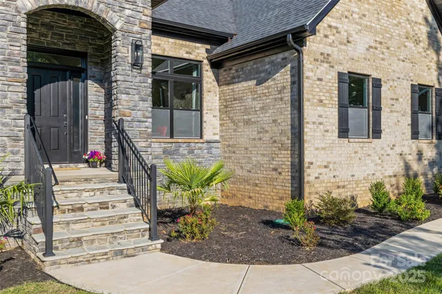 a front view of a house with a garden