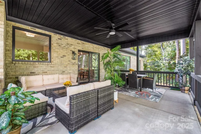 a outdoor space with patio the couches and a potted plant with the view of the balcony