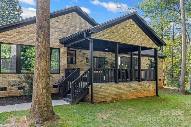 a view of a chair and table in backyard of the house