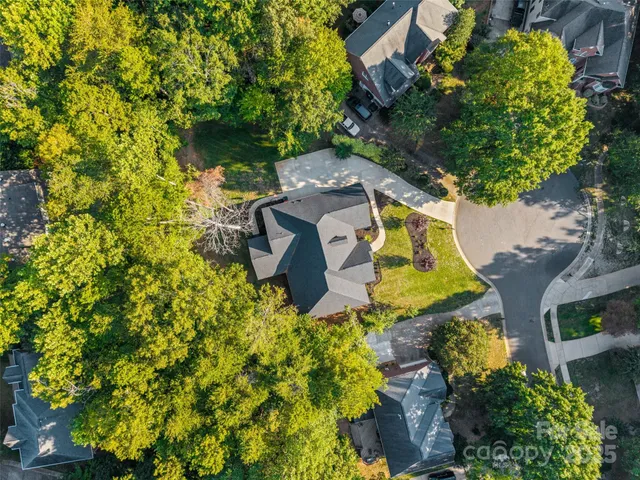an aerial view of a house with a yard basket ball court and outdoor seating