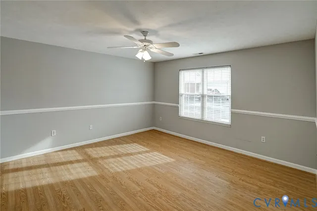 wooden floor in an empty room with a window