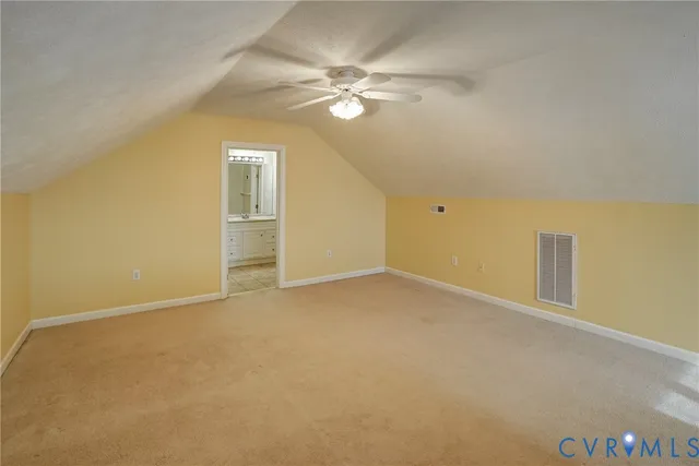 a view of an empty room with a ceiling fan