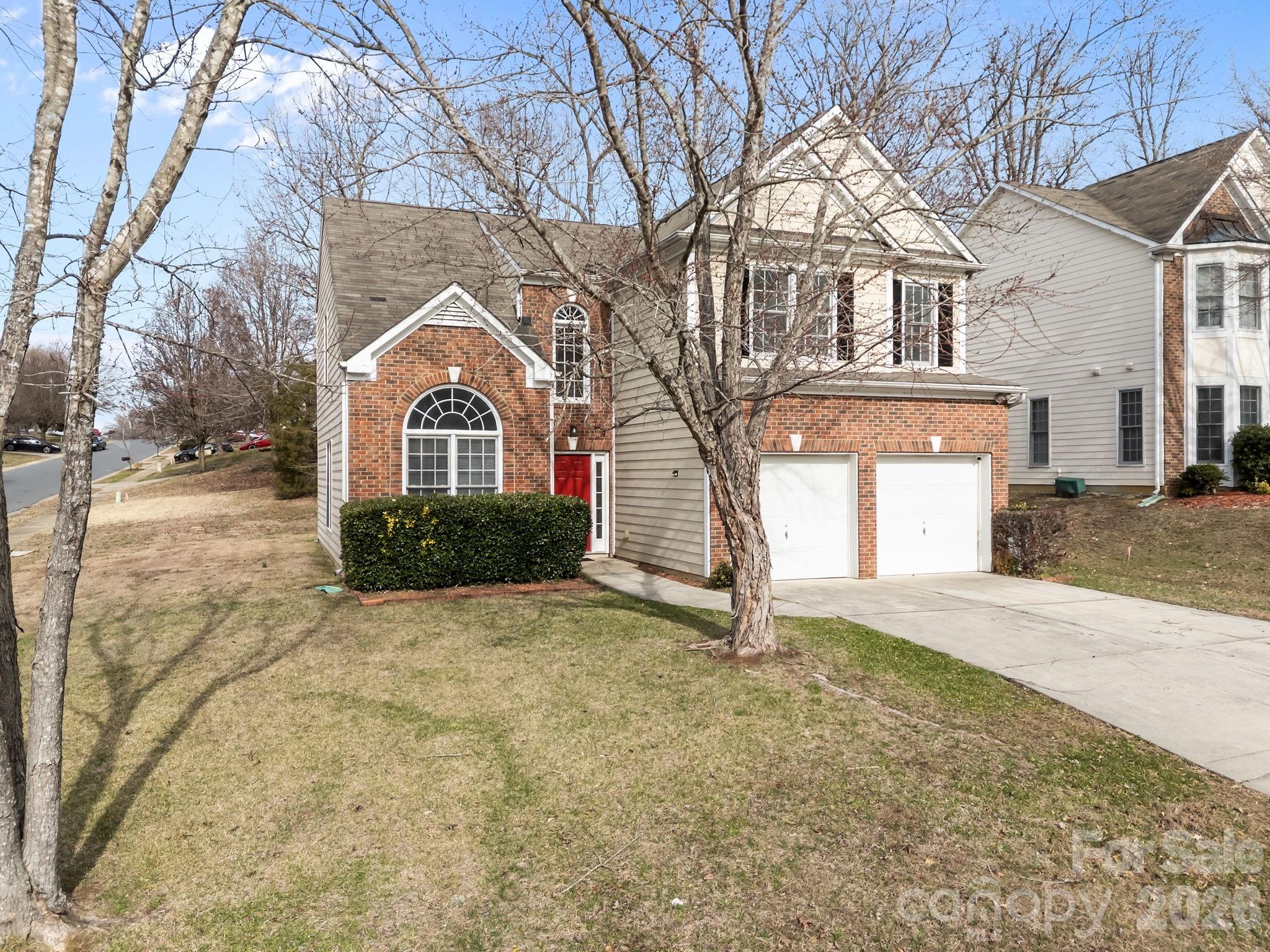 3203 Arklow Road Charlotte, NC 28269 - Photo 38 of 44 a front view of a house with a yard and garage