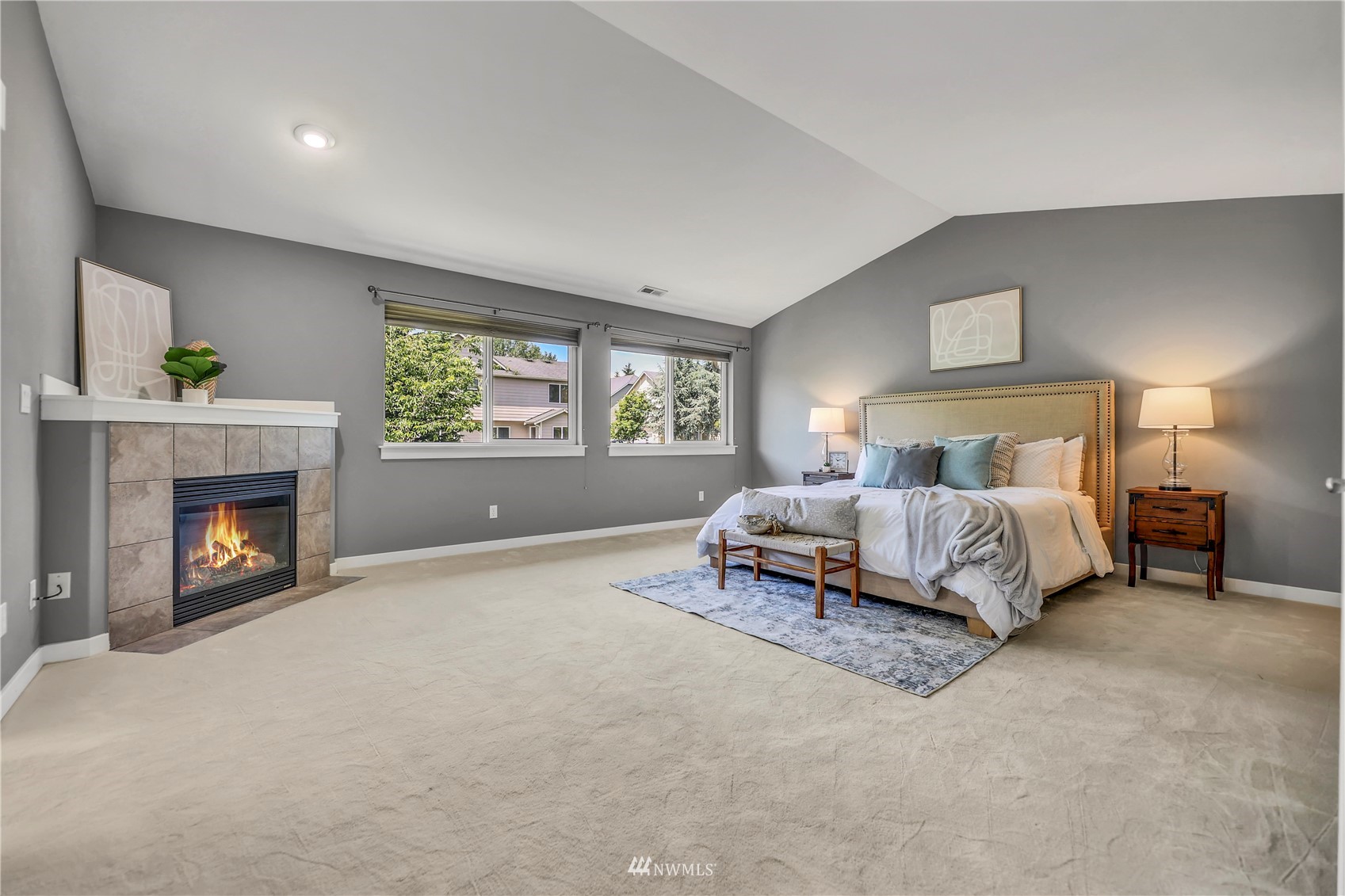 871 Jericho Place Northeast Renton, WA 98059 - Photo 15 of 31 a spacious bedroom with a bed and a fireplace