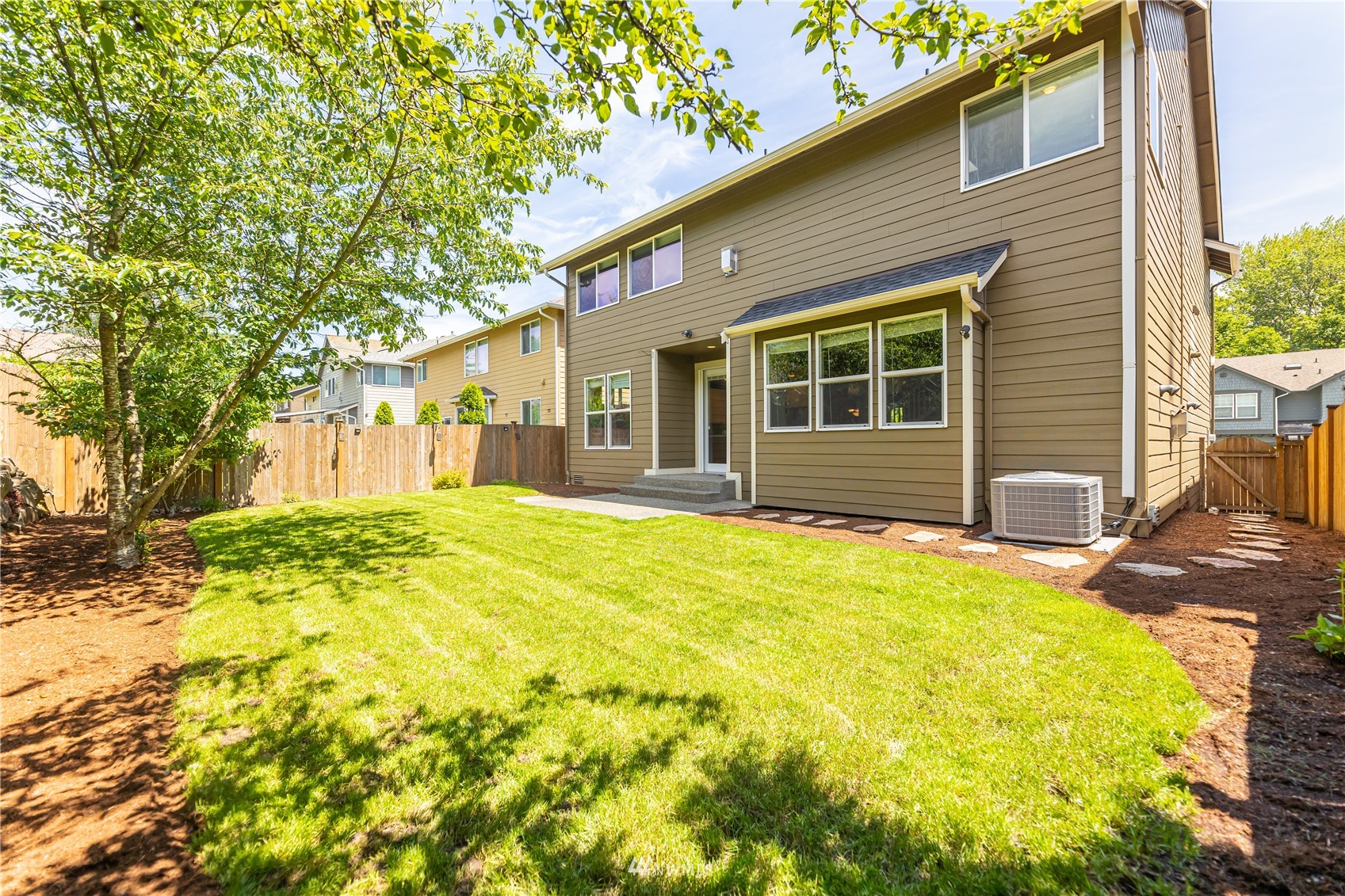 871 Jericho Place Northeast Renton, WA 98059 - Photo 28 of 31 a front view of a house with a yard and seating space