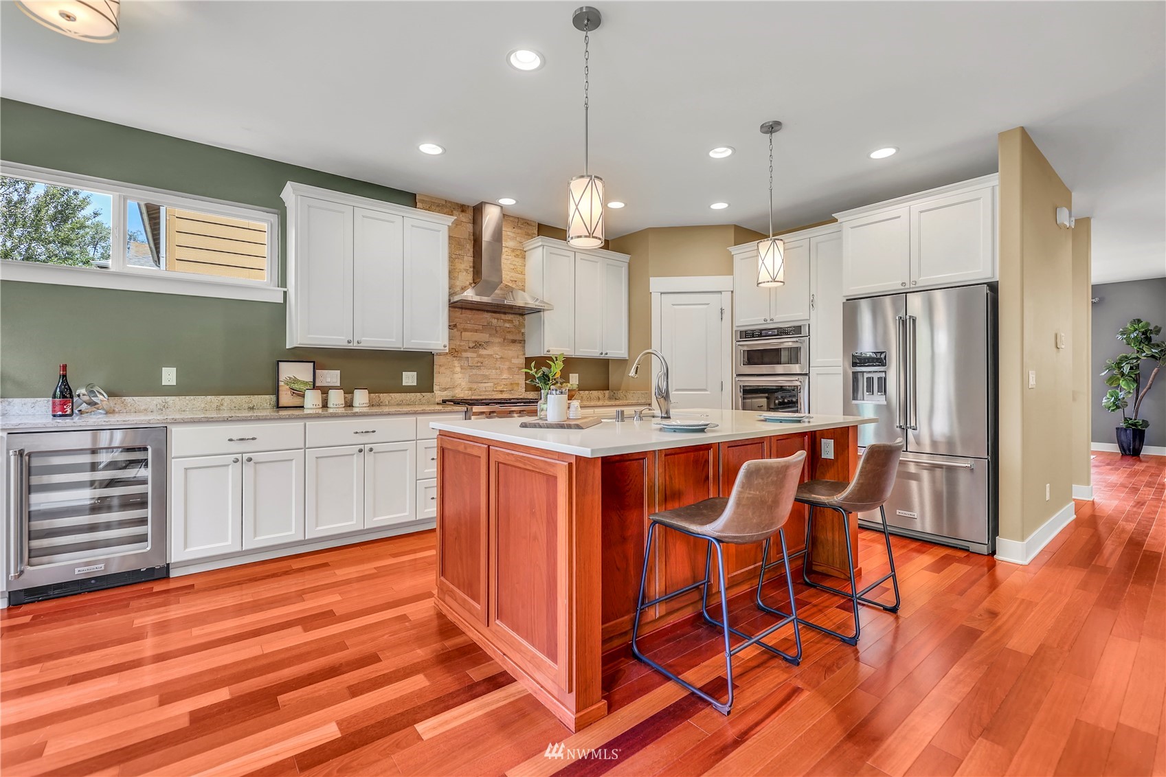 871 Jericho Place Northeast Renton, WA 98059 - Photo 5 of 31 a kitchen with stainless steel appliances kitchen island granite countertop wooden cabinets and a refrigerator