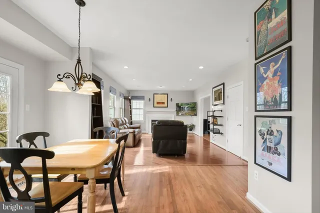 a bedroom with a bed chandelier and a window