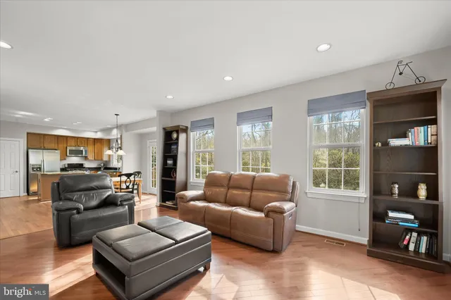 a spacious bedroom with a bed and a ceiling fan