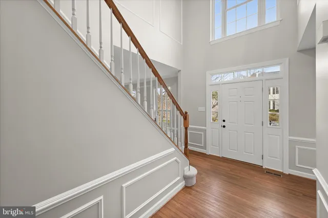 a living room with furniture and a window with wooden floor