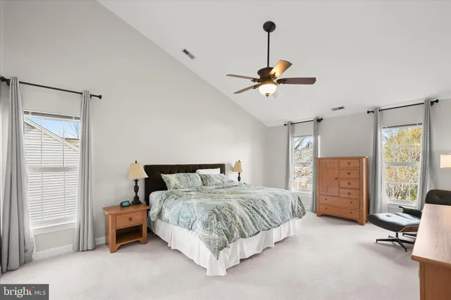 a spacious bedroom with a bed and a window