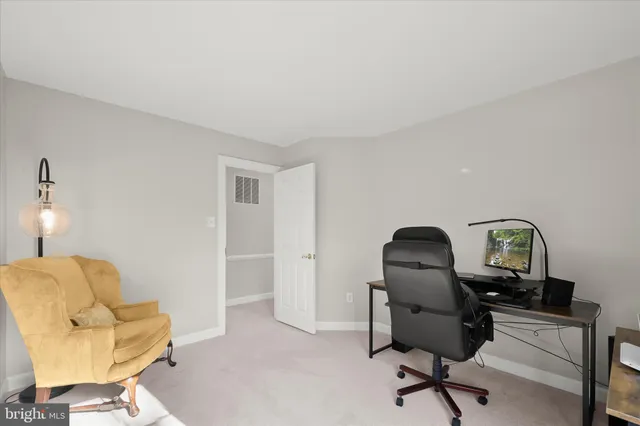 a chair and table in front of a house