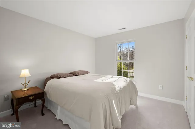 a front view of house with garden and trees