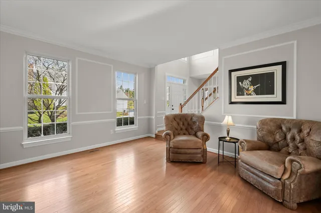 a dining room with furniture a chandelier and window